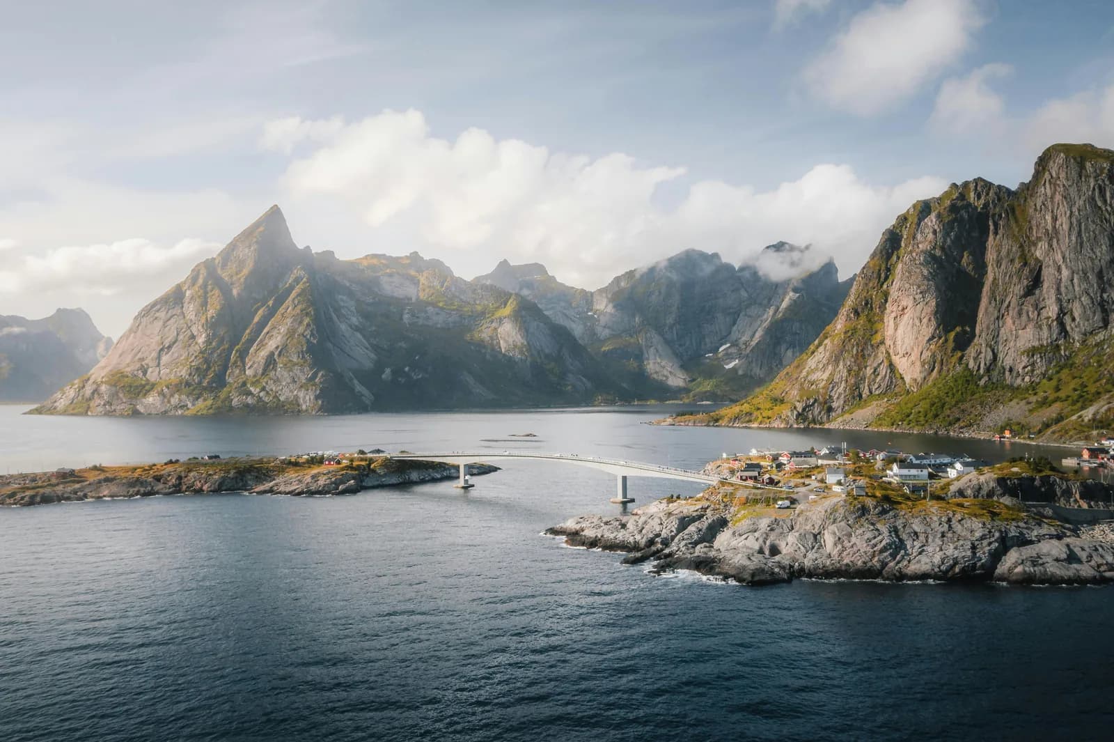 The bridge between Reinebringen and Hamnoy with peaks rising sharply from the water.