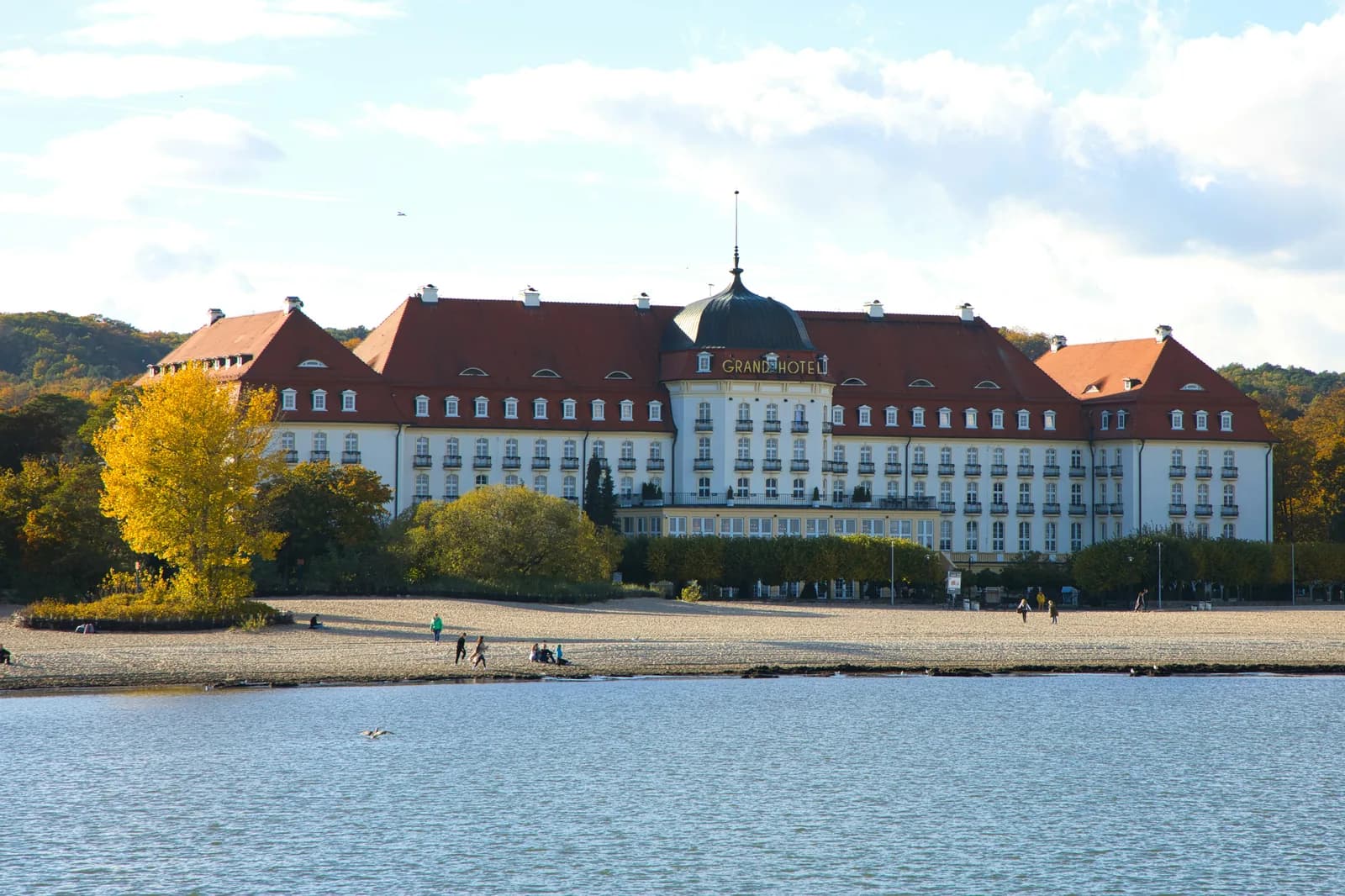 Grand Hotel facade seen from the Baltic with autumn trees and beach